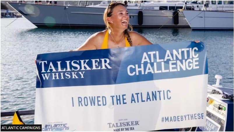 Lara Vafiadis atlantic completion with flag - credit Atlantic Campaign