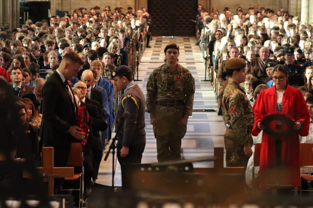 King's Remembrance Day OV James Smalley and Head of School Jasmine S receiving the Wreaths from the CCF Colour Party